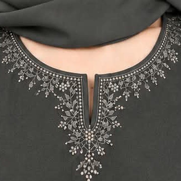Floral threadwork around the notched neckline